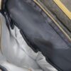 2026/10/1000786634-1.jpg mochila pañalera multifuncional de color gris melange con detalles dorados y un compartimento frontal y cambiador portátil